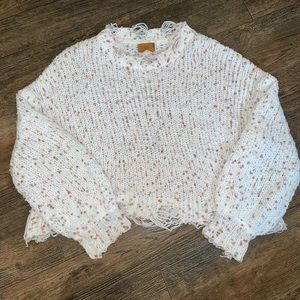 Cropped and distressed confetti sweater